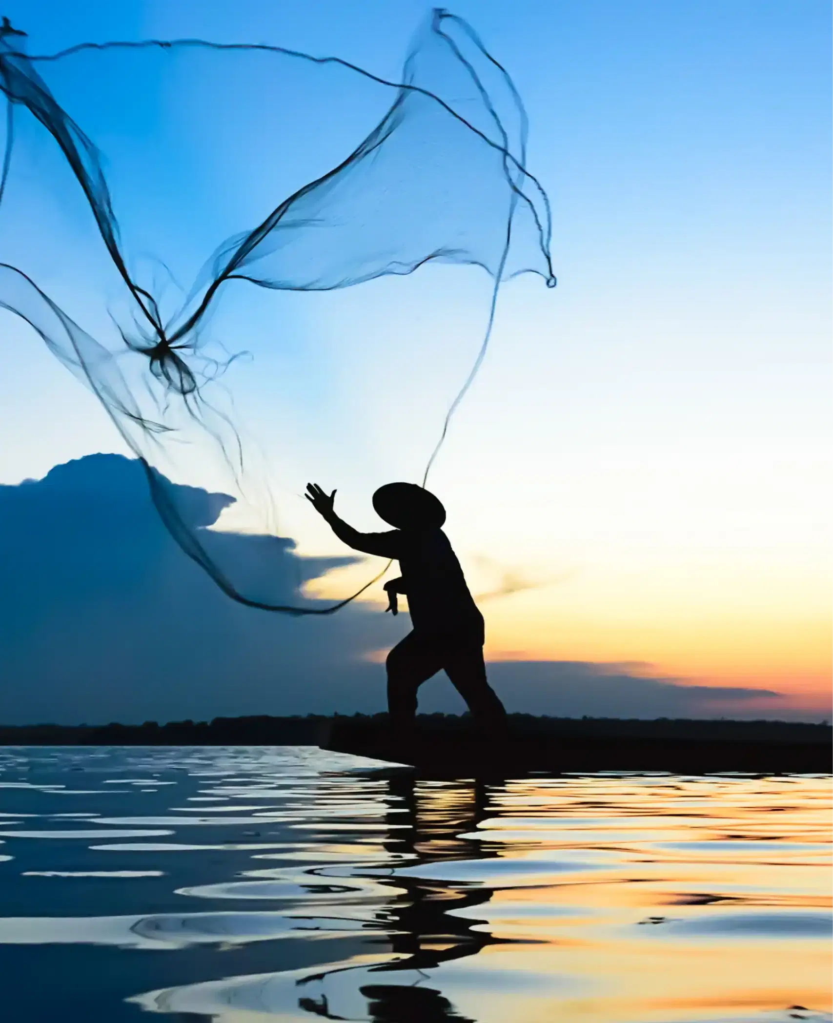 Man throwing a fishing net at sunset