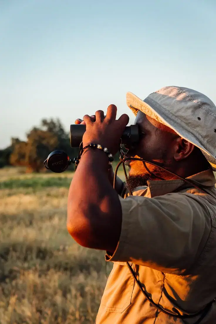 Man looking through binoculars